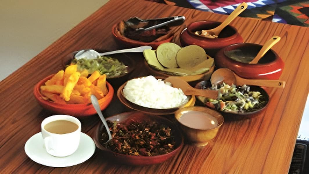 A traditional Bhutanese farmhouse meal spread in wooden bowls