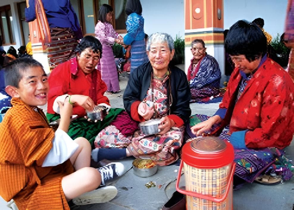 A Bhutanese family sharing a meal together in traditional dress