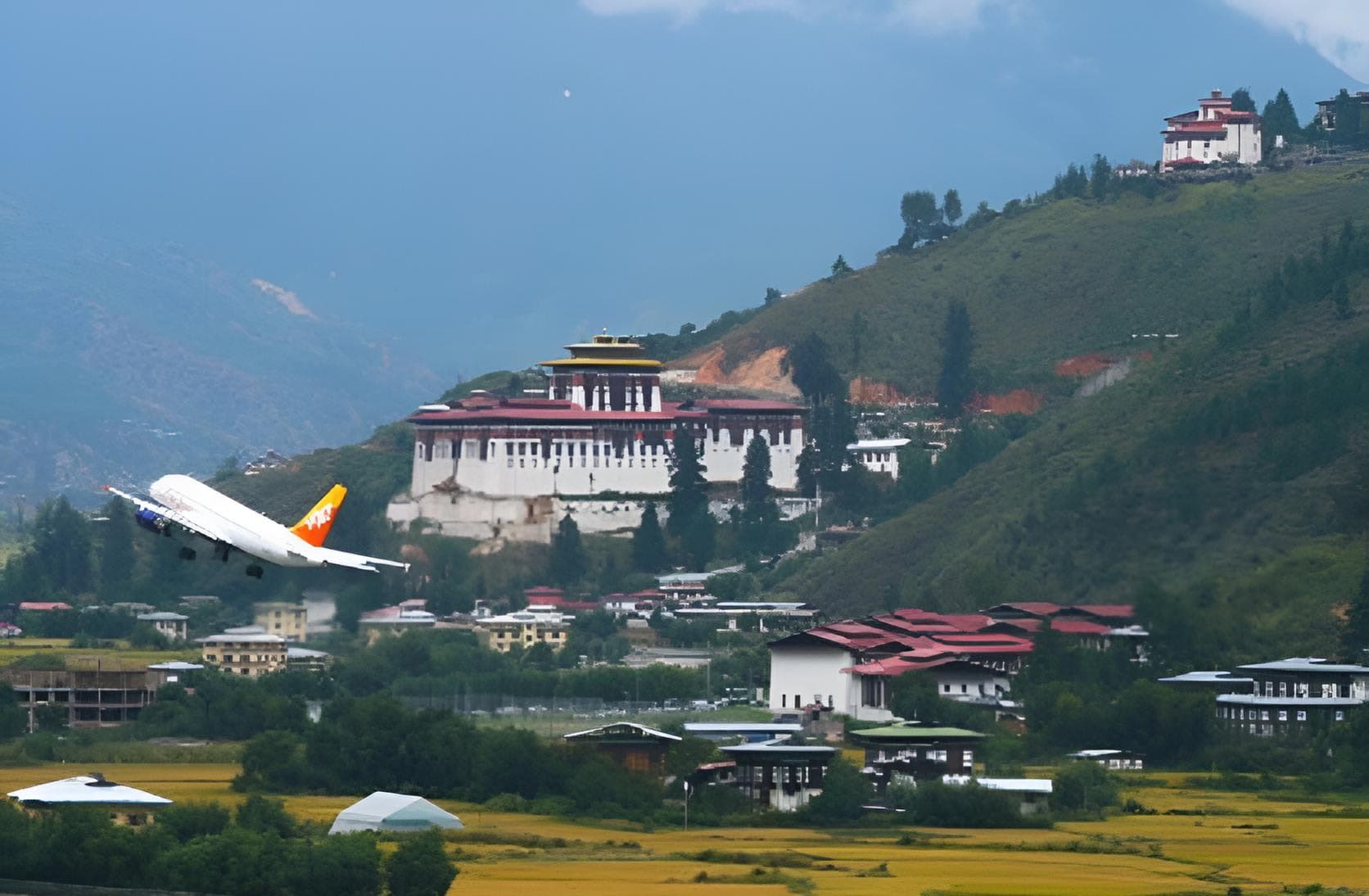 A Drukair plane taking off from Paro International Airport in the valley